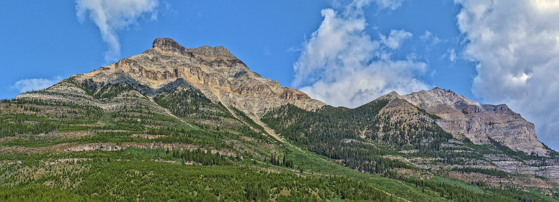 Snowy mountain peaks above a green valley